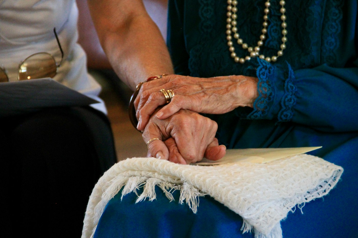 A caregiver comforting an older woman